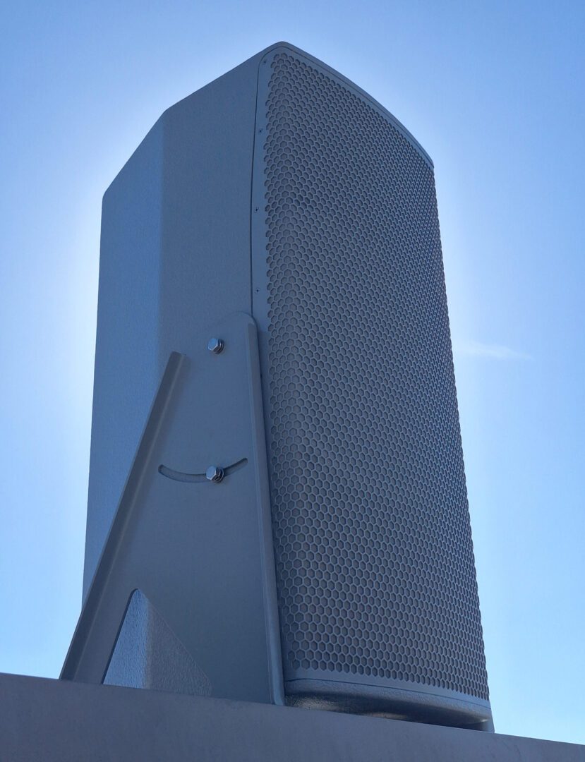 A tall white building with a sky background